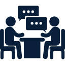 men couple sitting on a table talking about business
